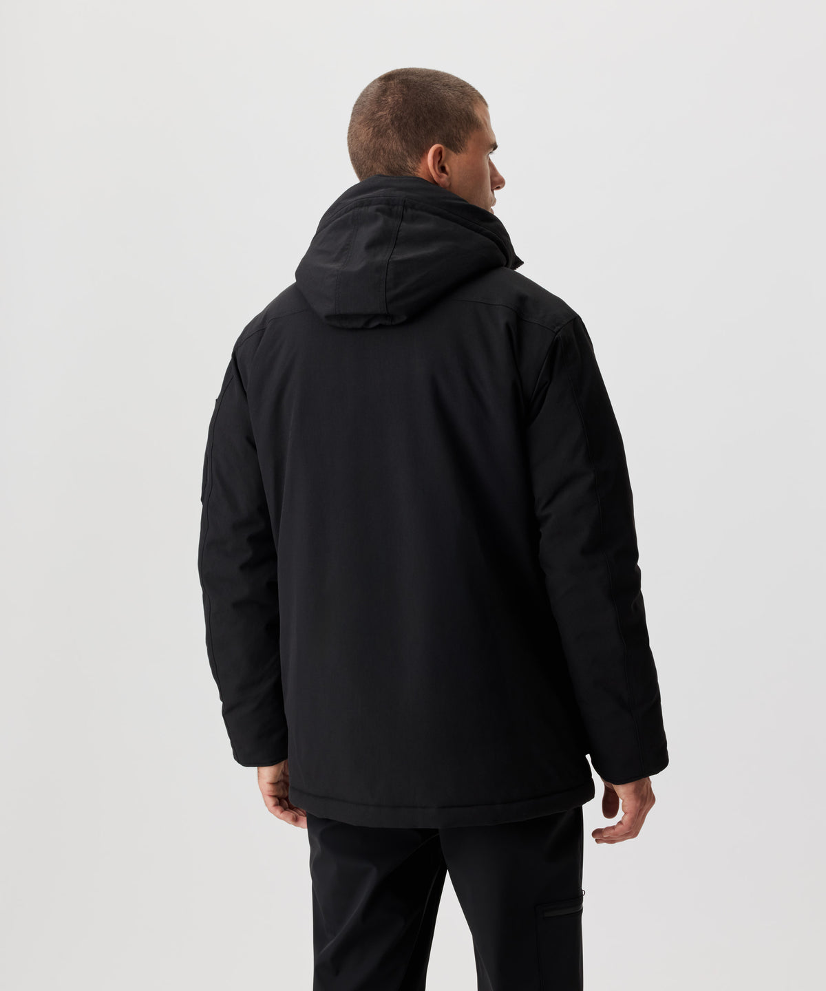 Rüclansicht Mann im schwarzen Winter-Parka.